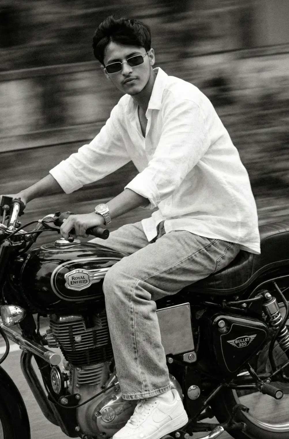 A slim-fit 5'7 young girl riding her black Royal Enfield  Bullet 350